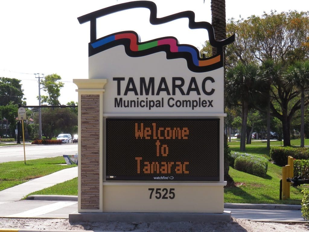 Sign that says Tamarac municipal complex with yellow lettered LED message board.